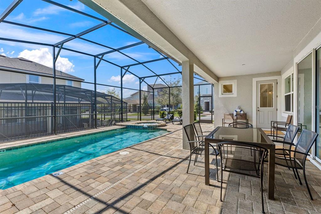 9042 Sunshine Ridge Loop Kissimmee, FL 34747 - Photo 14 of 44 a view of a patio with a table and chairs