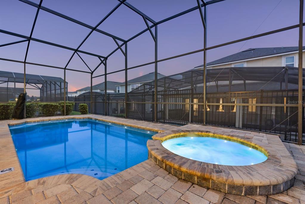 9042 Sunshine Ridge Loop Kissimmee, FL 34747 - Photo 18 of 44 a view of a swimming pool with a patio and plants