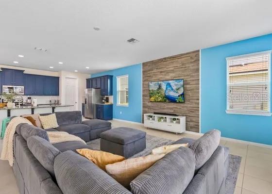 9042 Sunshine Ridge Loop Kissimmee, FL 34747 - Photo 2 of 44 a living room with furniture and a flat screen tv