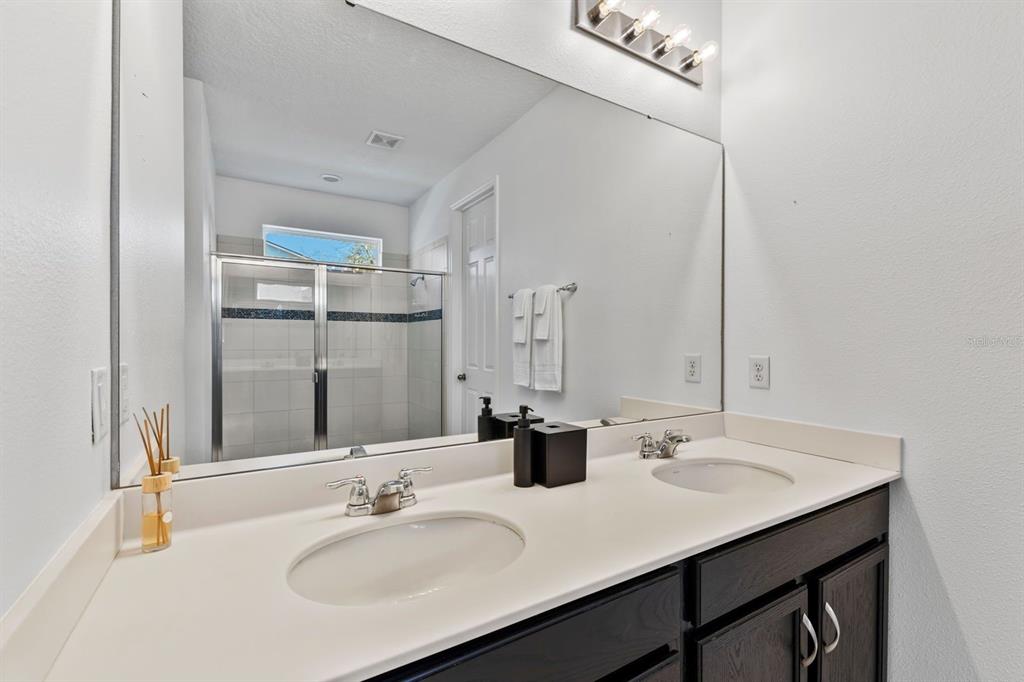 9042 Sunshine Ridge Loop Kissimmee, FL 34747 - Photo 21 of 44 a bathroom with a sink and a mirror