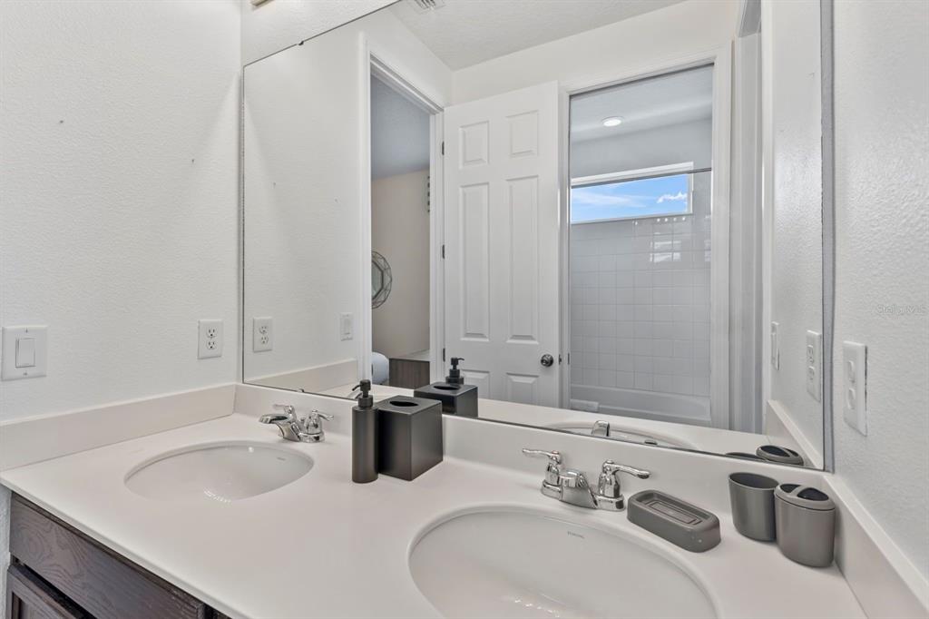 9042 Sunshine Ridge Loop Kissimmee, FL 34747 - Photo 23 of 44 a bathroom with a sink and a mirror