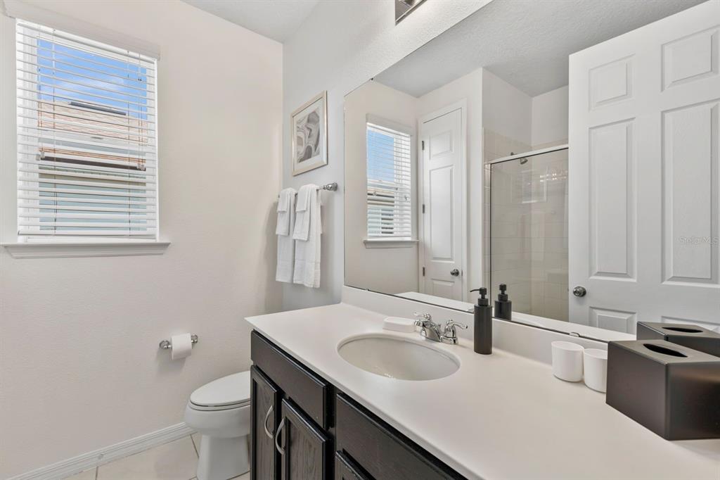 9042 Sunshine Ridge Loop Kissimmee, FL 34747 - Photo 28 of 44 a bathroom with a sink toilet double vanity and tub