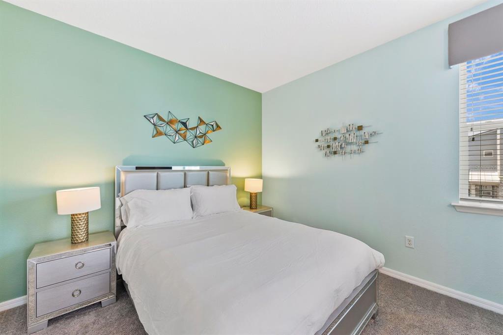 9042 Sunshine Ridge Loop Kissimmee, FL 34747 - Photo 29 of 44 a bedroom with a bed and a painting on the wall