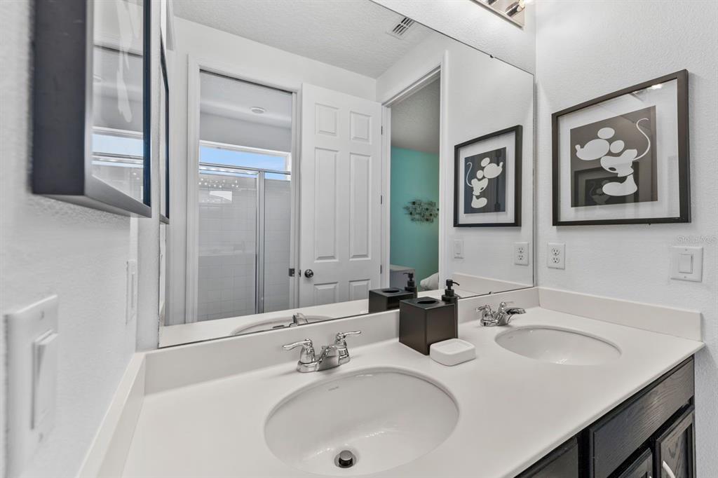 9042 Sunshine Ridge Loop Kissimmee, FL 34747 - Photo 30 of 44 a bathroom with a sink and a mirror