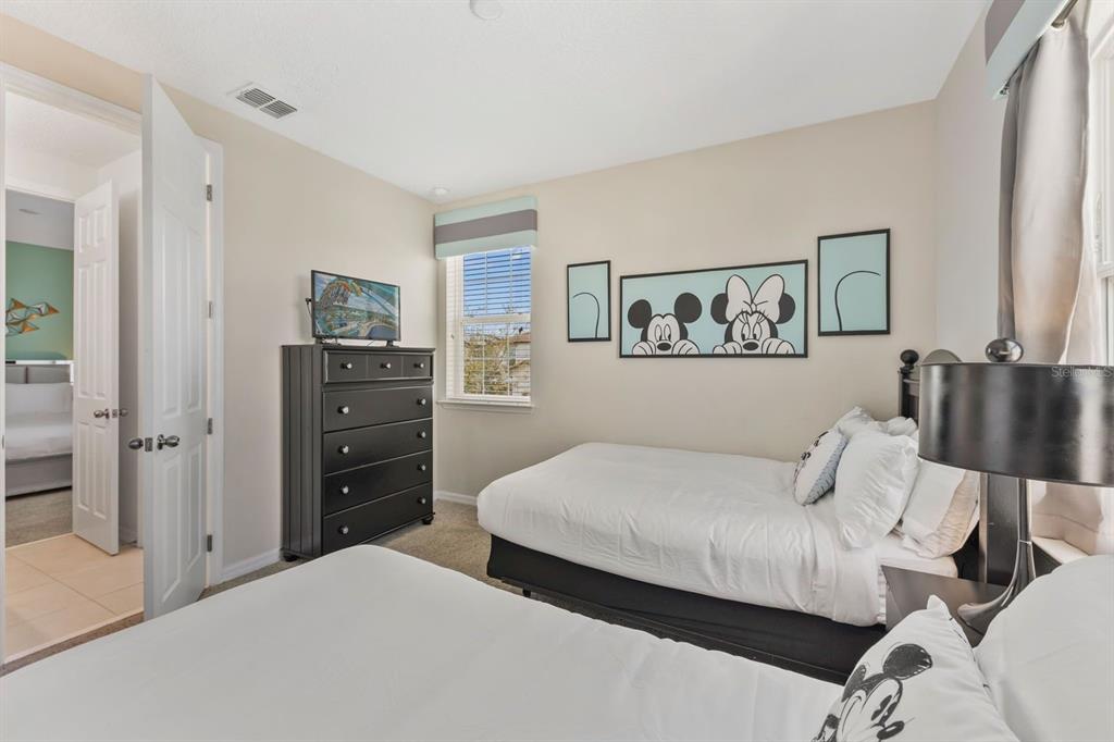 9042 Sunshine Ridge Loop Kissimmee, FL 34747 - Photo 31 of 44 a bedroom with a bed and painting on the wall