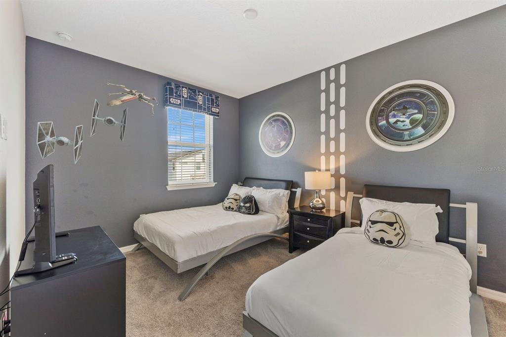 9042 Sunshine Ridge Loop Kissimmee, FL 34747 - Photo 32 of 44 a bedroom with two bed and a clock on the wall