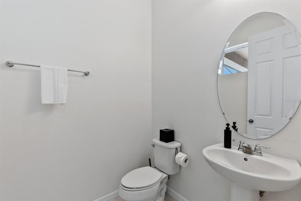 9042 Sunshine Ridge Loop Kissimmee, FL 34747 - Photo 34 of 44 a bathroom with a toilet sink and mirror