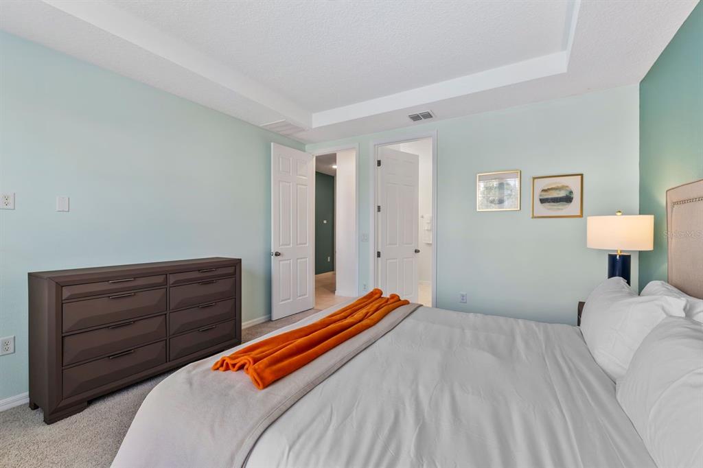 9042 Sunshine Ridge Loop Kissimmee, FL 34747 - Photo 35 of 44 a bedroom with a bed and dresser
