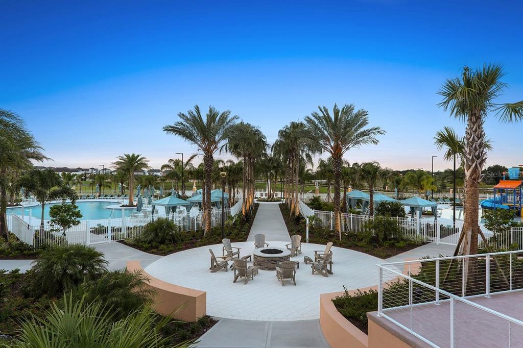 9042 Sunshine Ridge Loop Kissimmee, FL 34747 - Photo 43 of 44 a view of a lake with couches and table and chairs