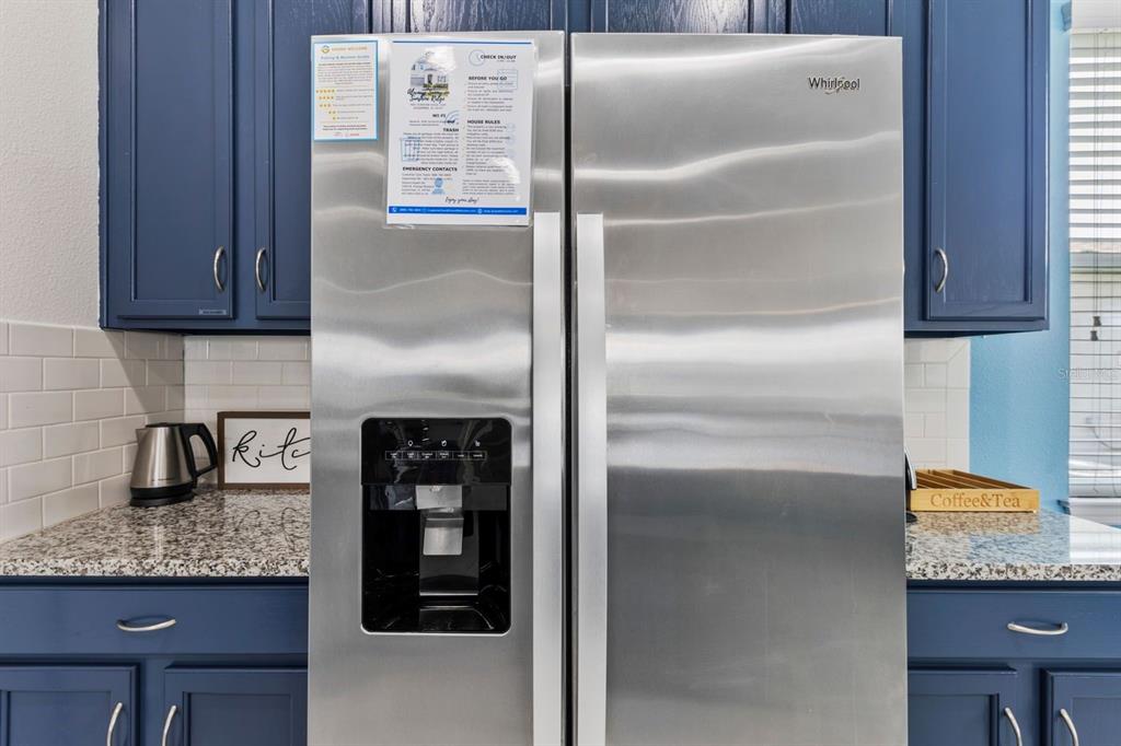 9042 Sunshine Ridge Loop Kissimmee, FL 34747 - Photo 7 of 44 a kitchen with granite countertop a refrigerator and a stove