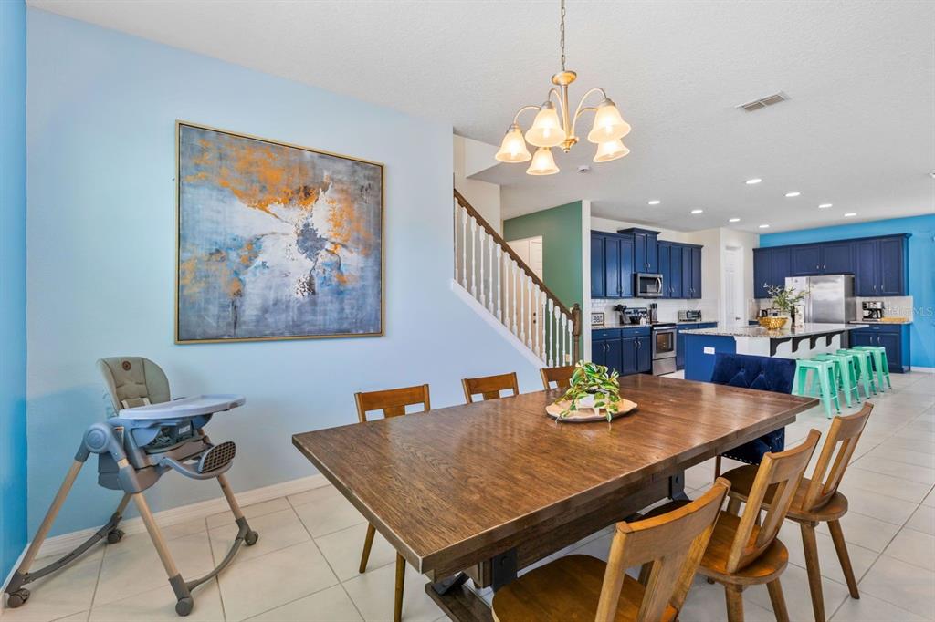9042 Sunshine Ridge Loop Kissimmee, FL 34747 - Photo 9 of 44 a view of a dining room with furniture and a chandelier