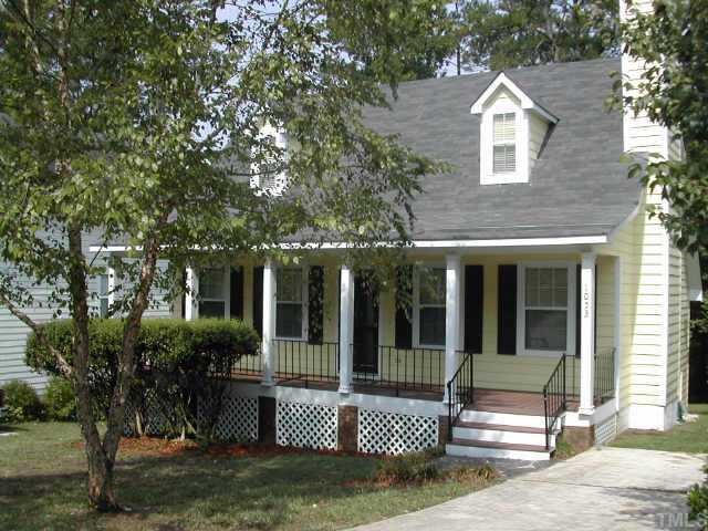 1053 Mills Street Raleigh, NC 27608 - Photo 1 of 10 a view of a brick house with large windows and a tree