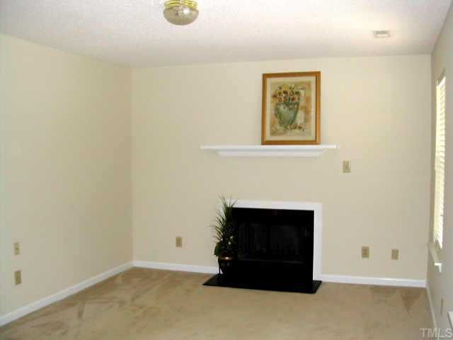 1053 Mills Street Raleigh, NC 27608 - Photo 3 of 10 a living room with furniture and a fireplace