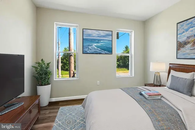 a bedroom with a bed and a flat screen tv