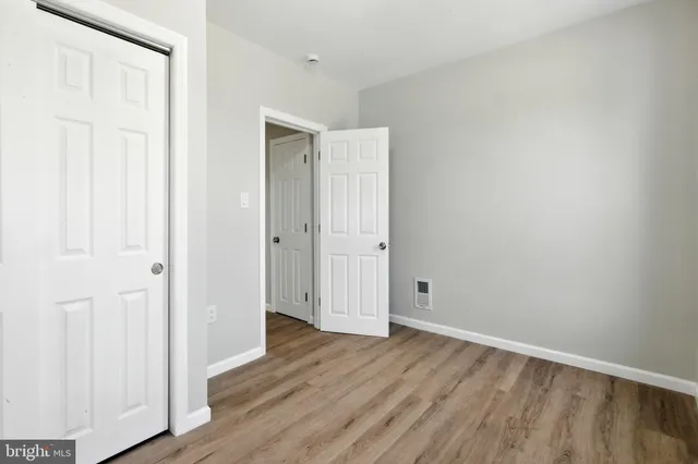 an empty room with wooden floor