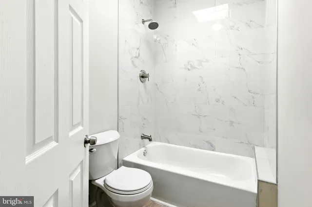 a bathroom with a toilet a sink and bathtub