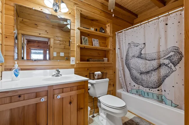 a bathroom with a sink a toilet and shower curtain