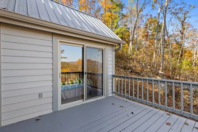 a view of backyard with a deck and wooden floor