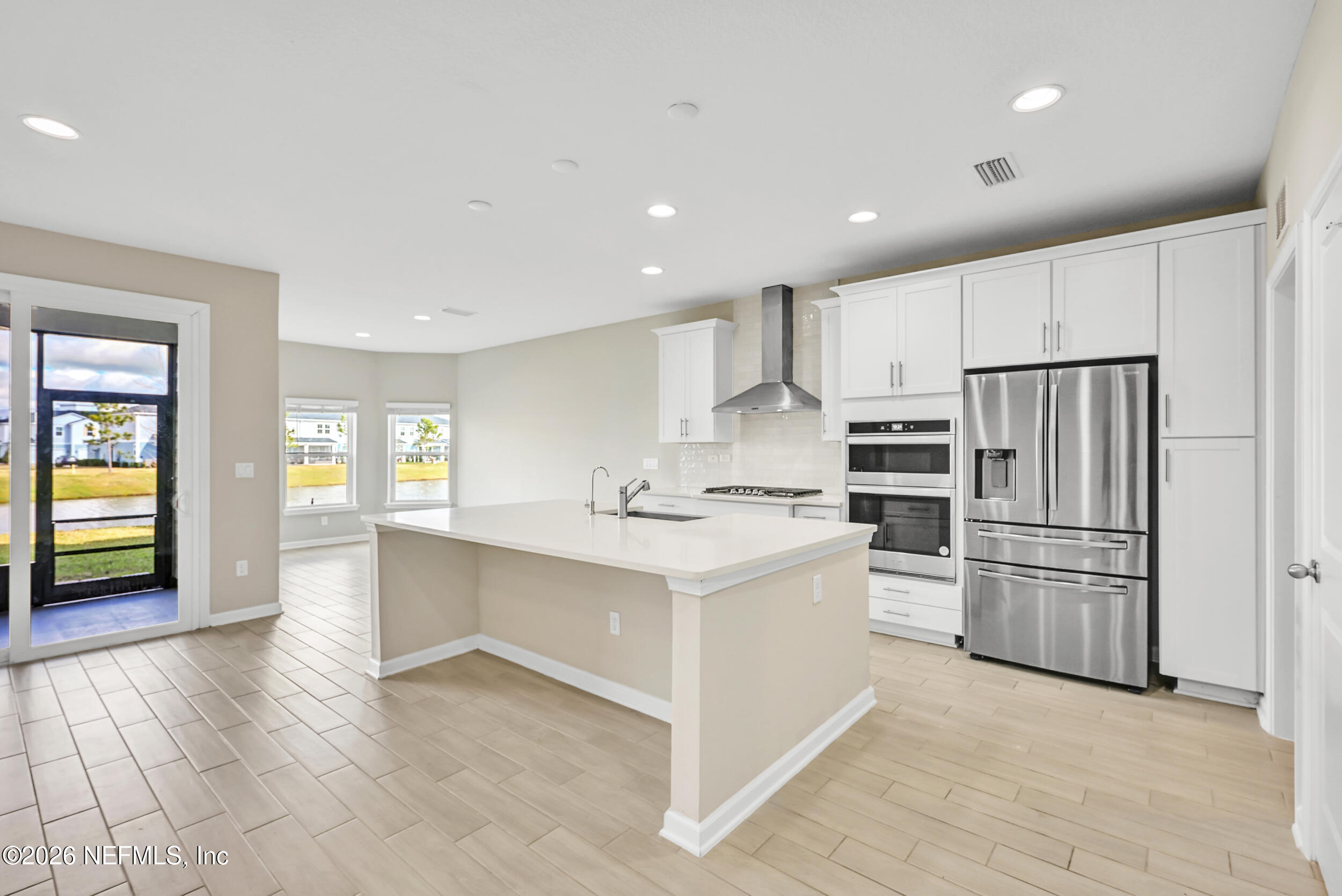 63 Goldcrest Way St. Augustine, FL 32092 - Photo 11 of 56 a kitchen with white cabinets and stainless steel appliances