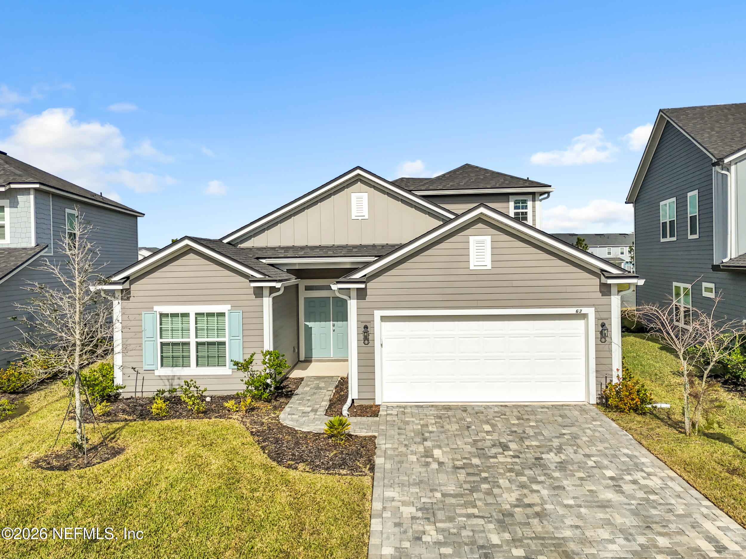 63 Goldcrest Way St. Augustine, FL 32092 - Photo 2 of 56 a front view of a house with a yard and garage