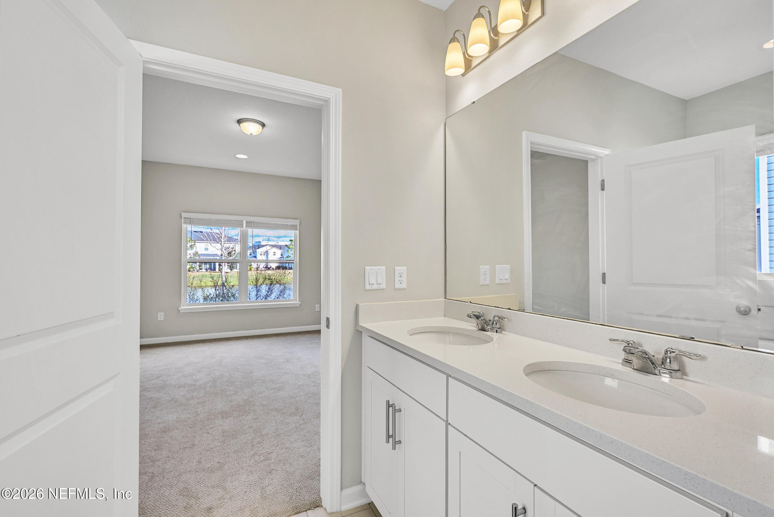63 Goldcrest Way St. Augustine, FL 32092 - Photo 24 of 56 a bathroom with 2 sink and a mirror