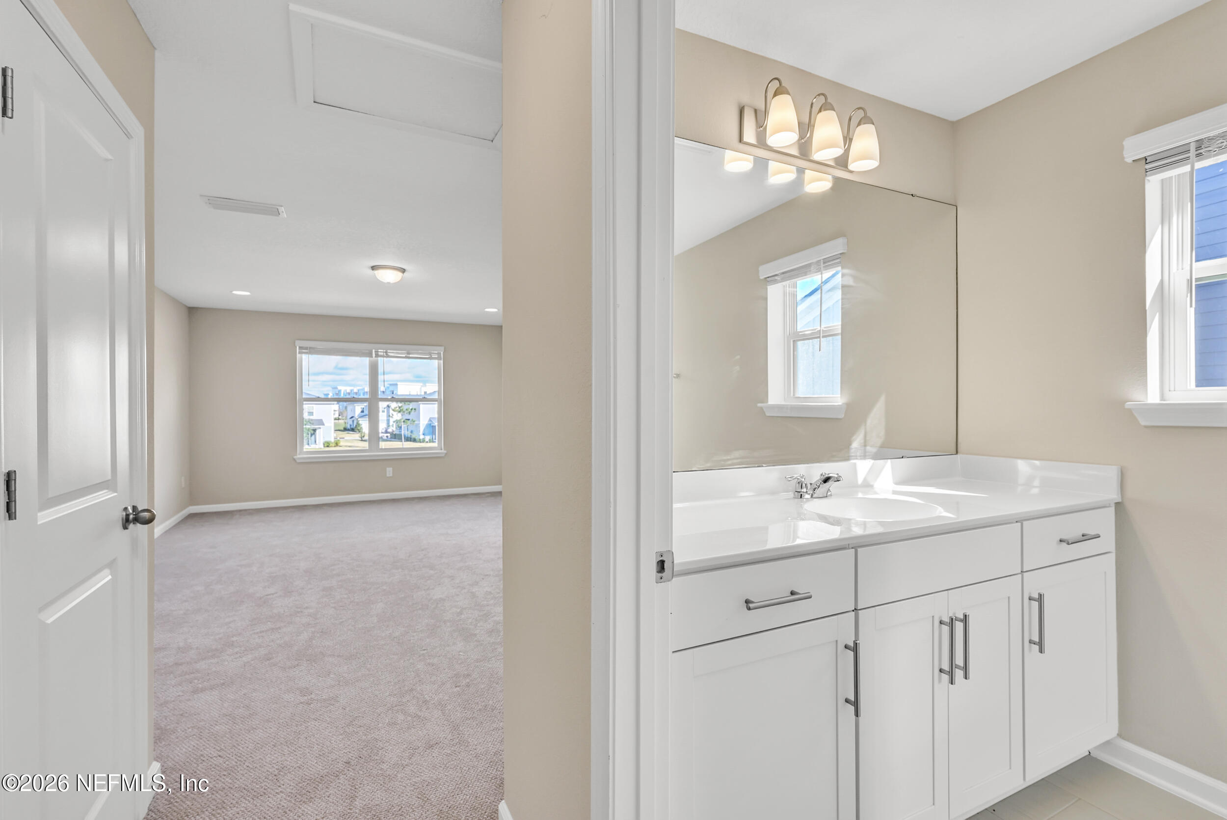 63 Goldcrest Way St. Augustine, FL 32092 - Photo 36 of 56 a bathroom with a granite countertop sink mirror and a window