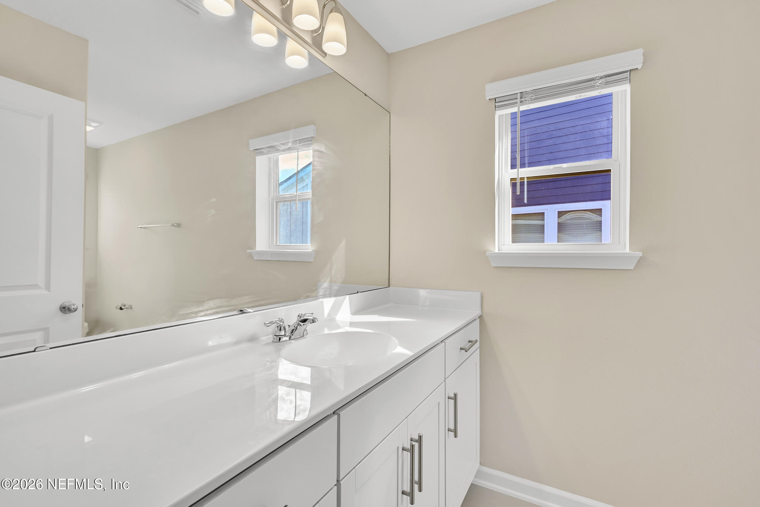 63 Goldcrest Way St. Augustine, FL 32092 - Photo 37 of 56 a bathroom with a sink a vanity and a mirror