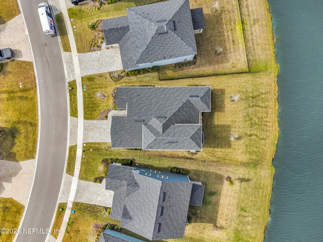 a view of kitchen with wooden floor and electronic appliances