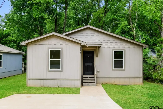 a house with a yard plants in the back