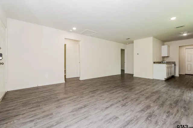 a view of a kitchen with a sink and a refrigerator