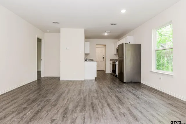 a view of a refrigerator in kitchen and wooden floor