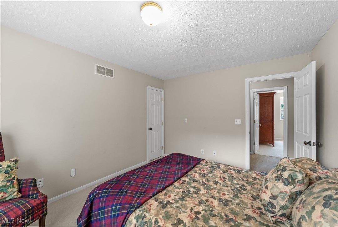 30825 Cannon Road Solon, OH 44139 - Photo 30 of 49 Carpeted bedroom with a textured ceiling and baseboards