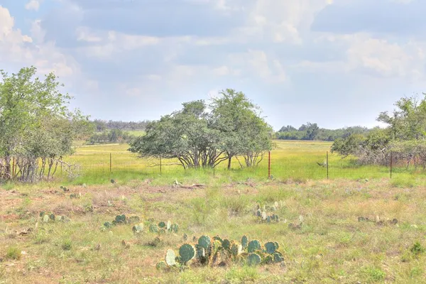 a view of lake with table and chairs