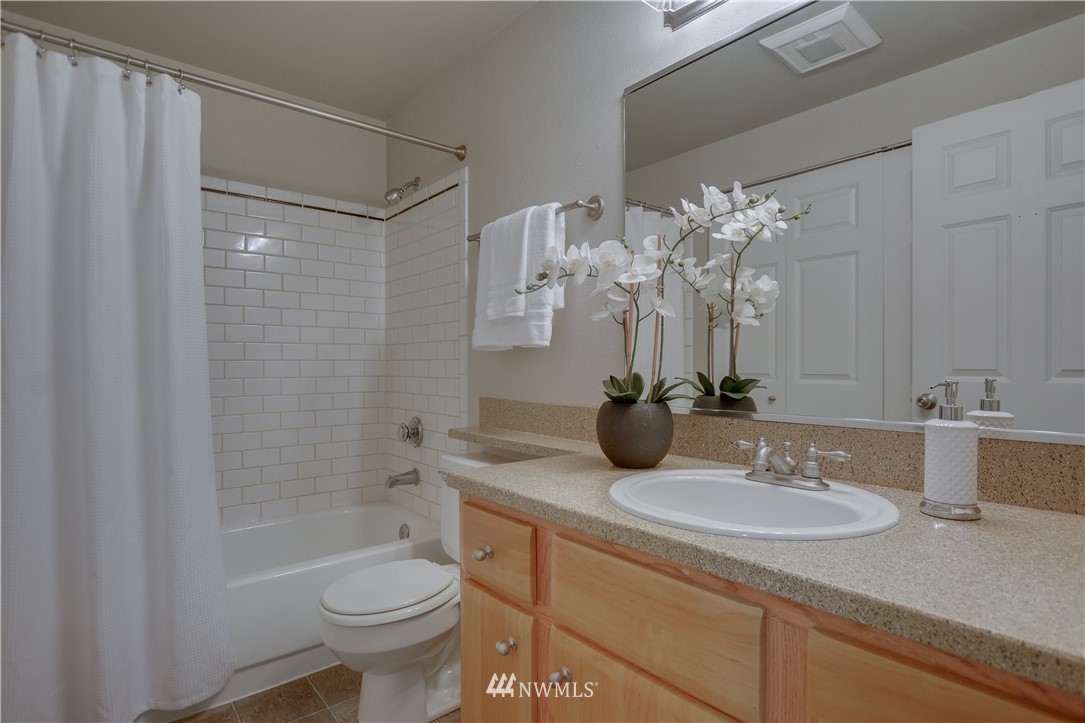 9200 Greenwood Avenue North, Unit 104 Seattle, WA 98103 - Photo 15 of 19 a bathroom with a sink a toilet and shower