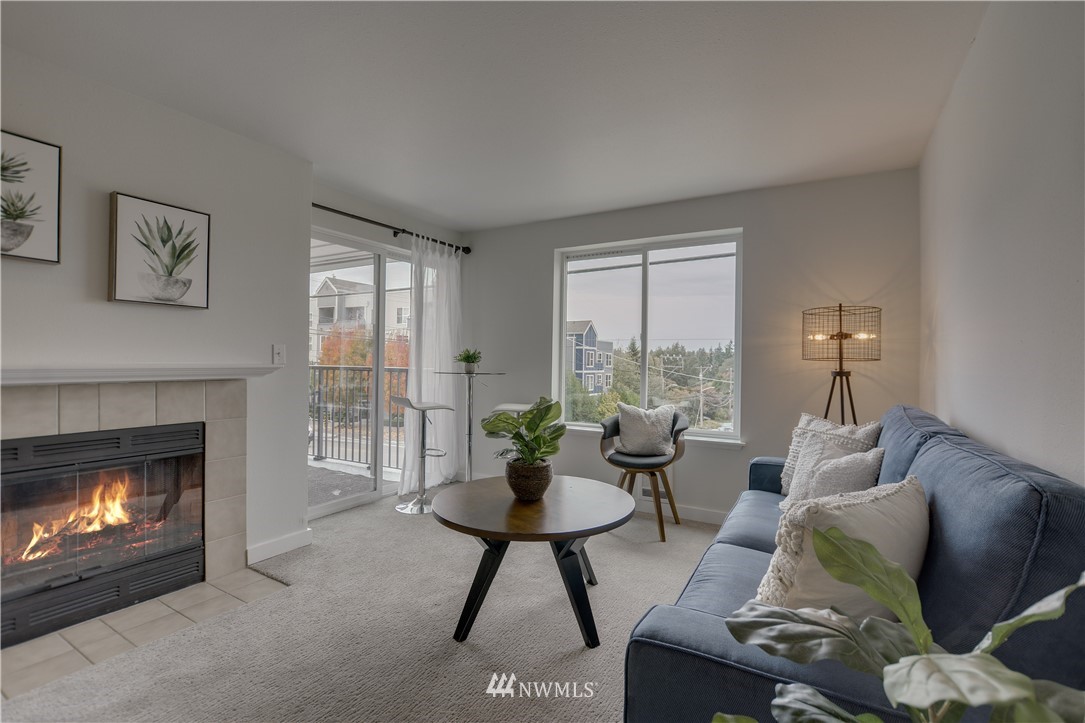 9200 Greenwood Avenue North, Unit 104 Seattle, WA 98103 - Photo 3 of 19 a living room with furniture and a fireplace