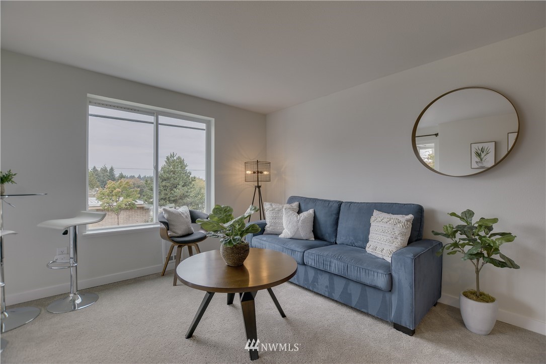 9200 Greenwood Avenue North, Unit 104 Seattle, WA 98103 - Photo 4 of 19 a living room with furniture potted plant and a window