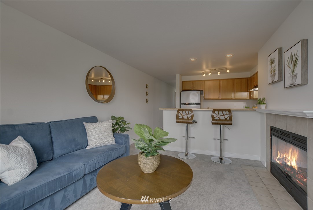 9200 Greenwood Avenue North, Unit 104 Seattle, WA 98103 - Photo 5 of 19 a living room with furniture and a fireplace