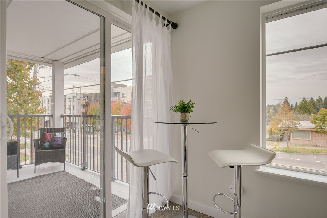 9200 Greenwood Avenue North, Unit 104 Seattle, WA 98103 - Photo 7 of 19 a view of a room with a large window and wooden floor
