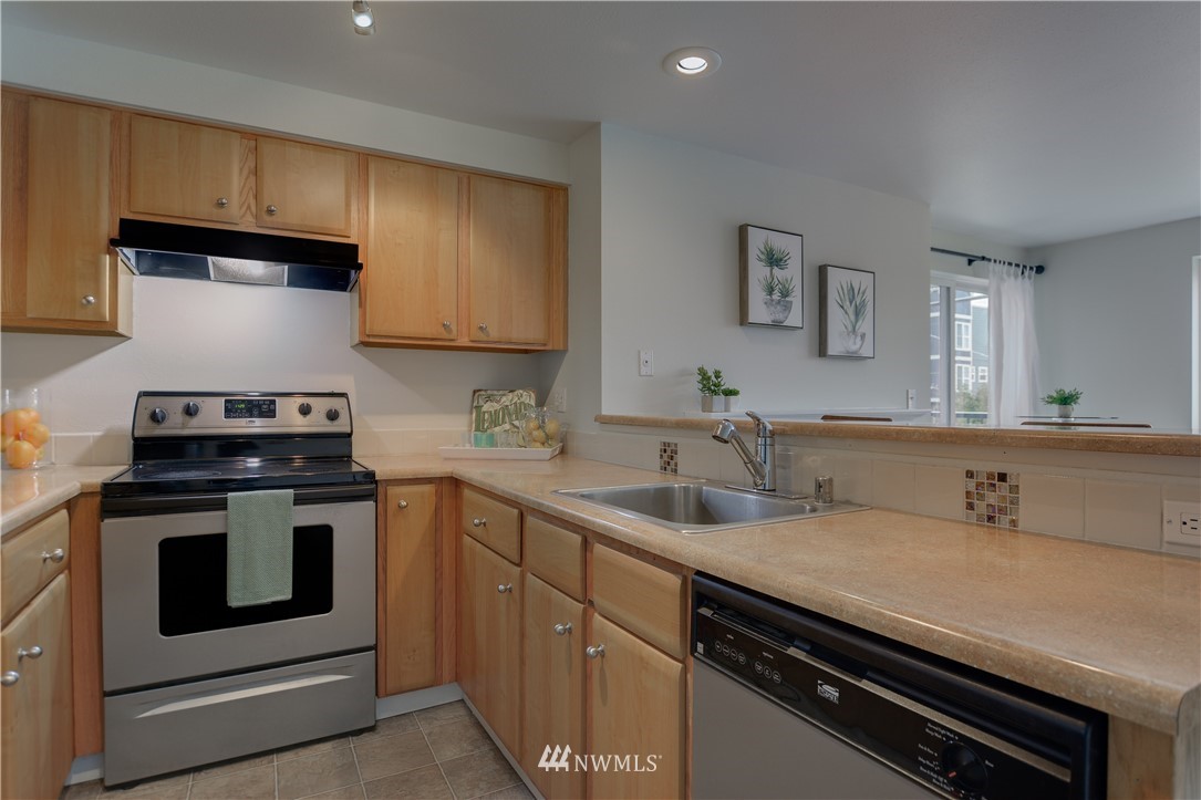 9200 Greenwood Avenue North, Unit 104 Seattle, WA 98103 - Photo 10 of 19 a kitchen with sink stove and cabinets