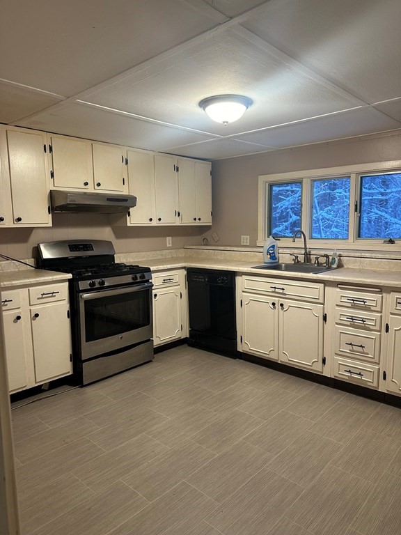 65 Shawsheen Road Billerica, MA 01821 - Photo 3 of 10 a kitchen with stainless steel appliances granite countertop a stove sink and cabinets