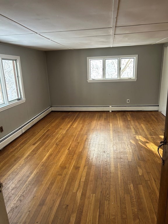 65 Shawsheen Road Billerica, MA 01821 - Photo 5 of 10 an empty room with wooden floor and windows