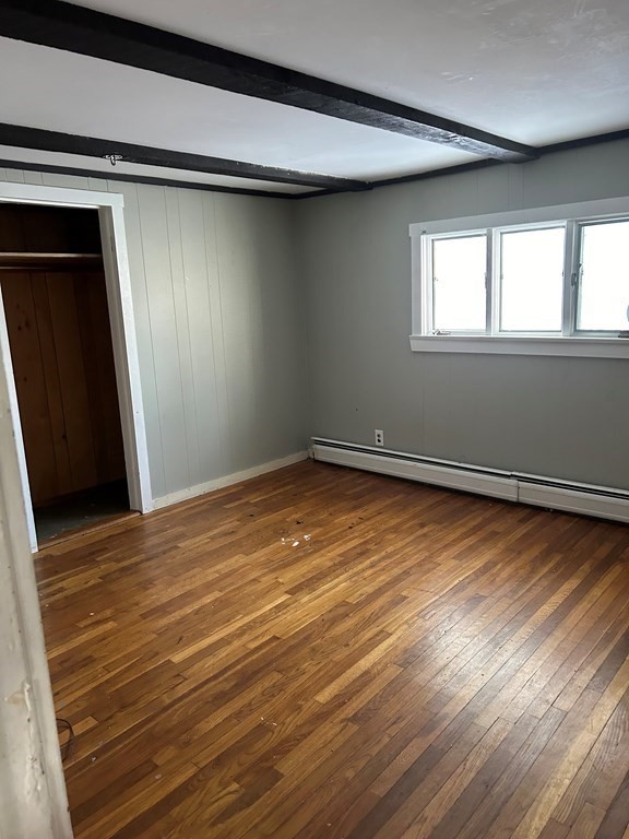 65 Shawsheen Road Billerica, MA 01821 - Photo 7 of 10 a view of an empty room with wooden floor and a window