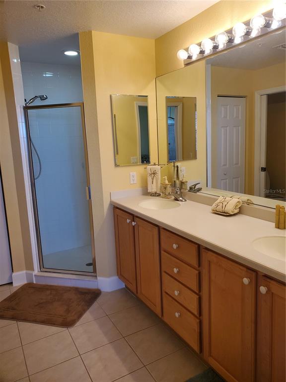 13413 Gasparilla Road, Unit 304 Placida, FL 33946 - Photo 16 of 28 a bathroom with a granite countertop sink and a mirror