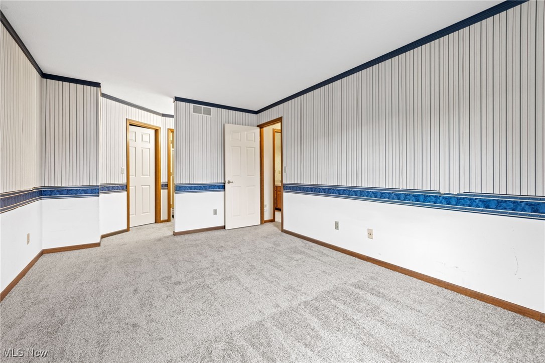 31655 Arthur Road Solon, OH 44139 - Photo 14 of 27 Empty room with ornamental molding and light colored carpet