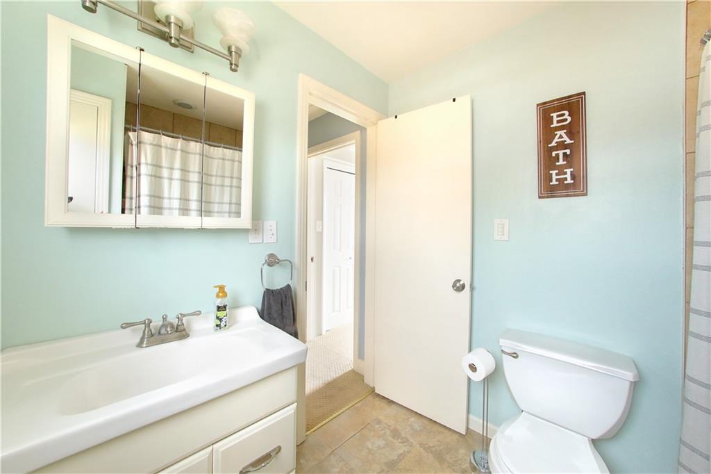 985 Ridge Road Bridgeville, PA 15017 - Photo 14 of 22 HALL BATH WITH CERAMIC FLOOR, STORAGE UNDER THE SINK, TUB/SHOWER COMBO.