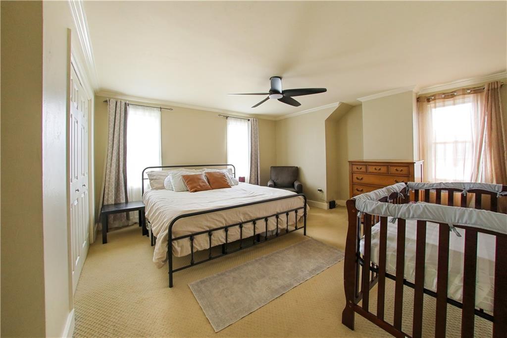 985 Ridge Road Bridgeville, PA 15017 - Photo 10 of 22 SPACIOUS PRIMARY BEDROOM SUPPORTS A KING SIZE BED WITH ADDITIONAL WALL SPACE FOR FURNITURE. DOUBLE CLOSET IS ONE OF 2 CLOSETS.