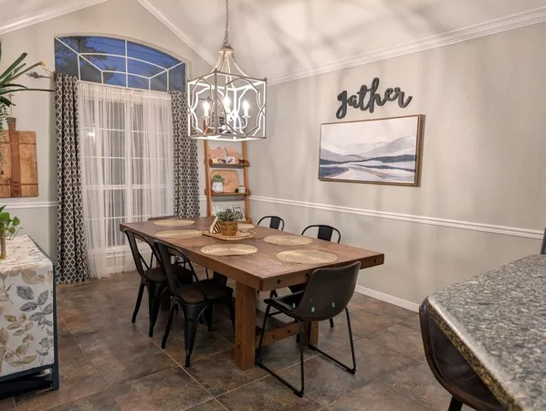 a view of a dining room with furniture and chandelier