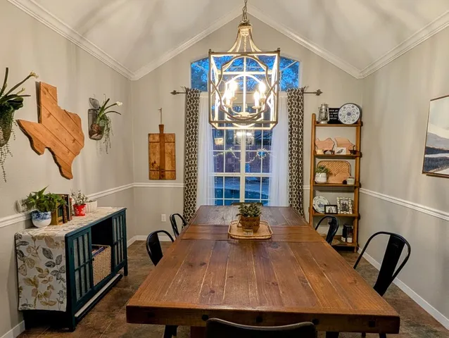 a view of a dining room with furniture and chandelier