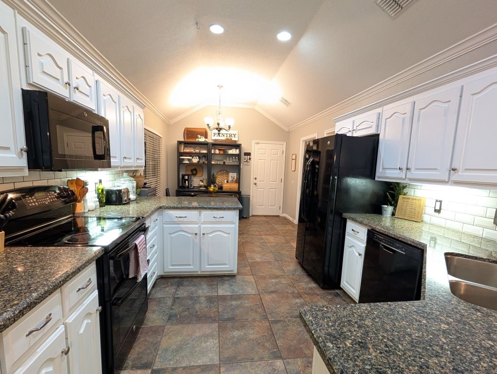 1231 Radisson Drive Hewitt, TX 76643 - Photo 18 of 51 a kitchen with a sink a stove top oven a refrigerator and cabinets