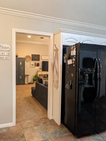 a view of a hallway and a livingroom with furniture